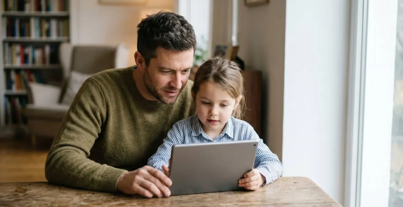 Parent and child thoughtfully reviewing educational content together on a tablet in natural light